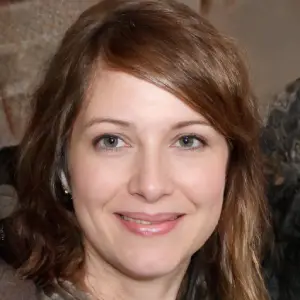 A close-up portrait of a happy, smiling middle-aged woman, a satisfied Kerassentials customer.